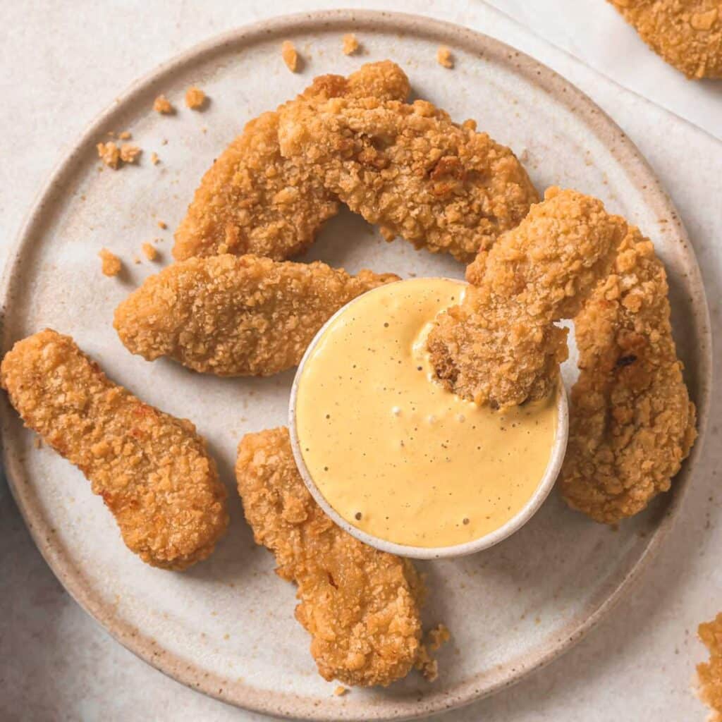 Chicken tenders served with chick fil a sauce.