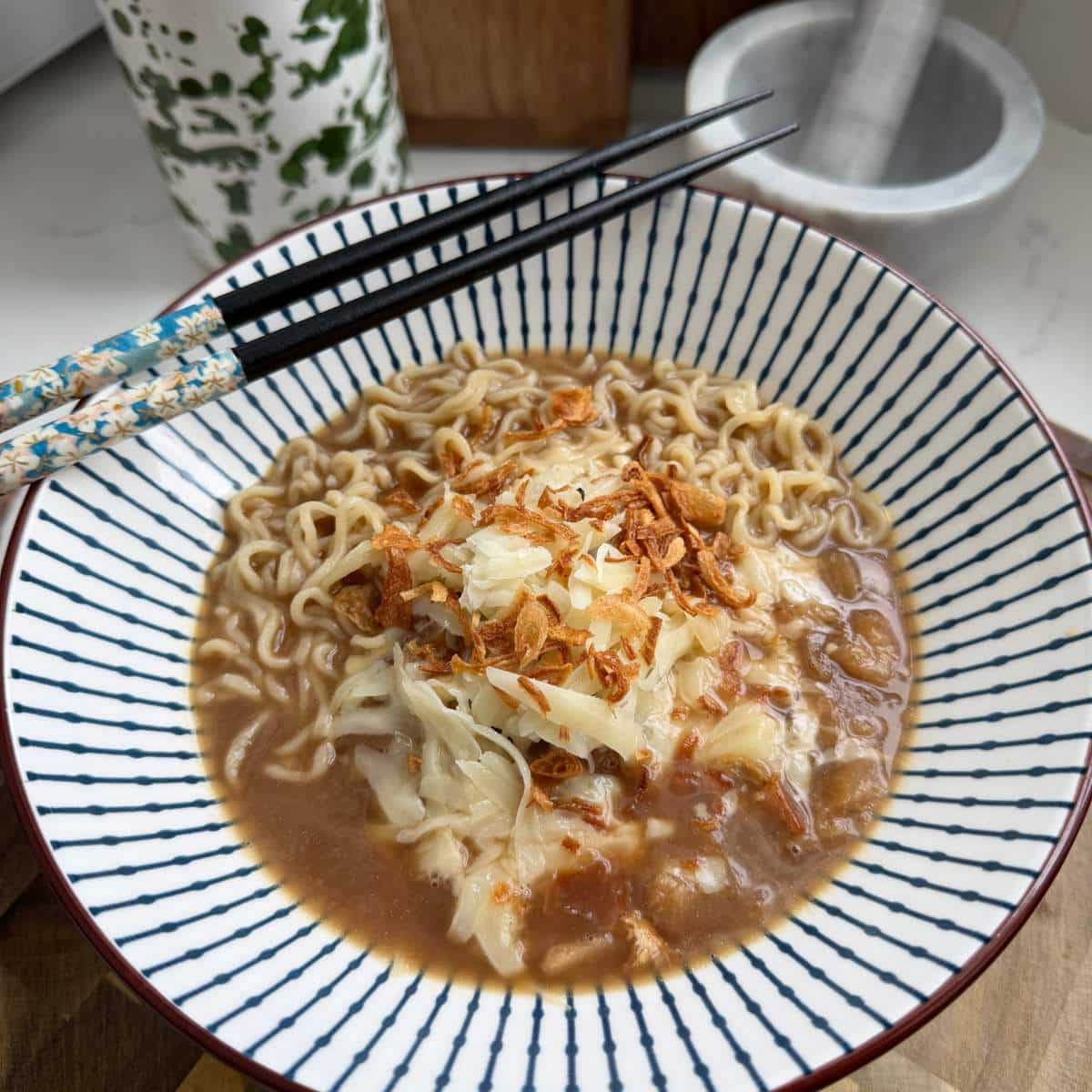 French Onion Ramen served with chopsticks.