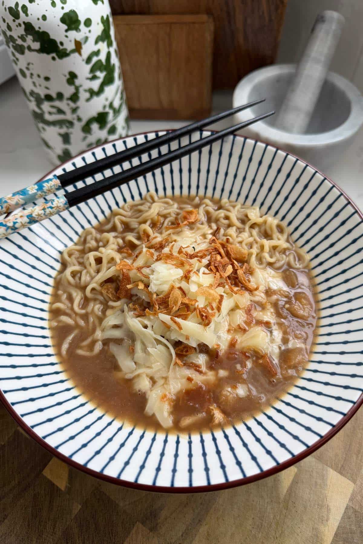 French Onion Ramen served with chopsticks.
