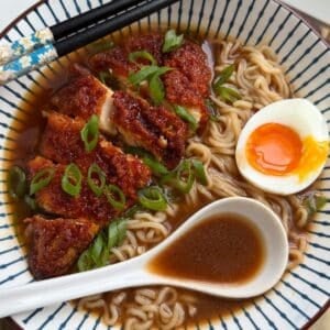 Gochujang Honey Chicken Ramen served in a bowl with a soft-boiled egg and chopsticks.