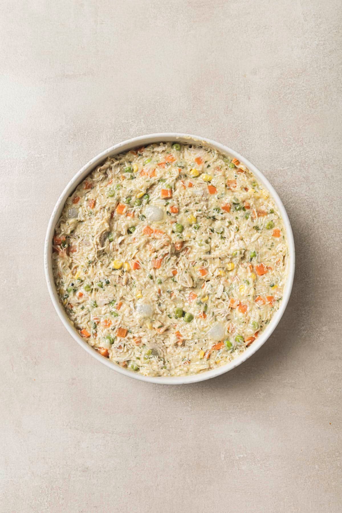 Uncooked pot pie mixture in a baking dish.