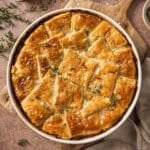 Puff pastry chicken pot pie garnished with fresh thyme.