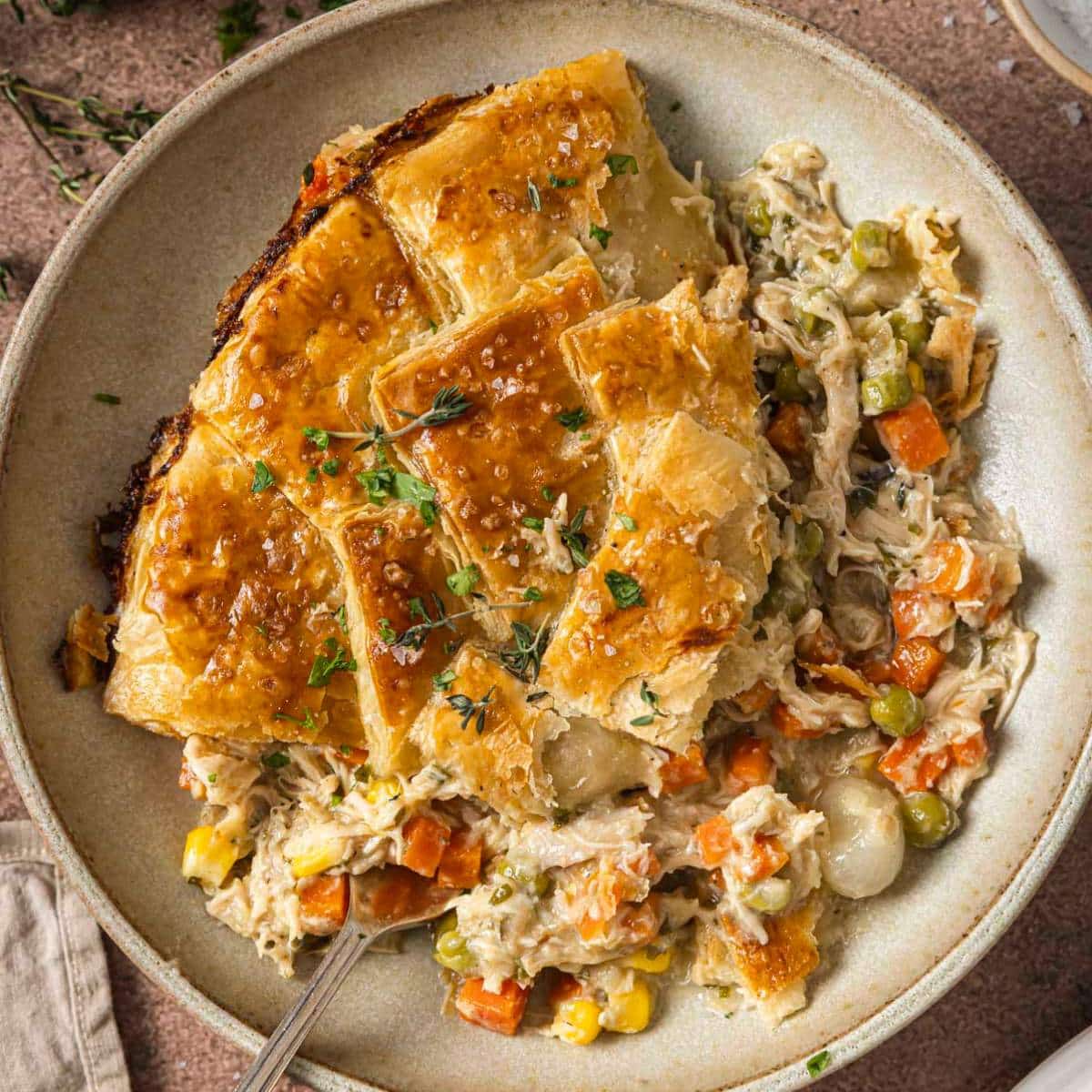 Serving of puff pastry chicken pot pie in a bowl.