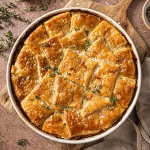 Puff pastry chicken pot pie garnished with fresh thyme.