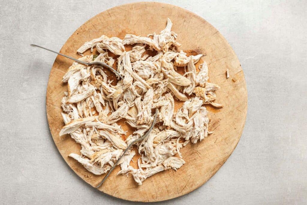 chicken for the fajita soup on a cutting board after being shredded. 