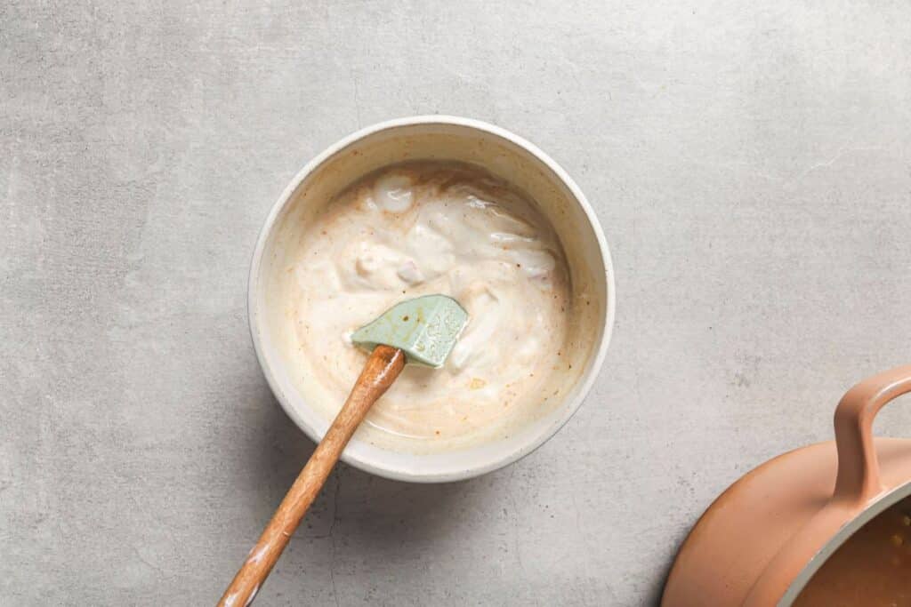 a small bowl of sour cream and hot broth to temper it before being added to the chicken fajita soup