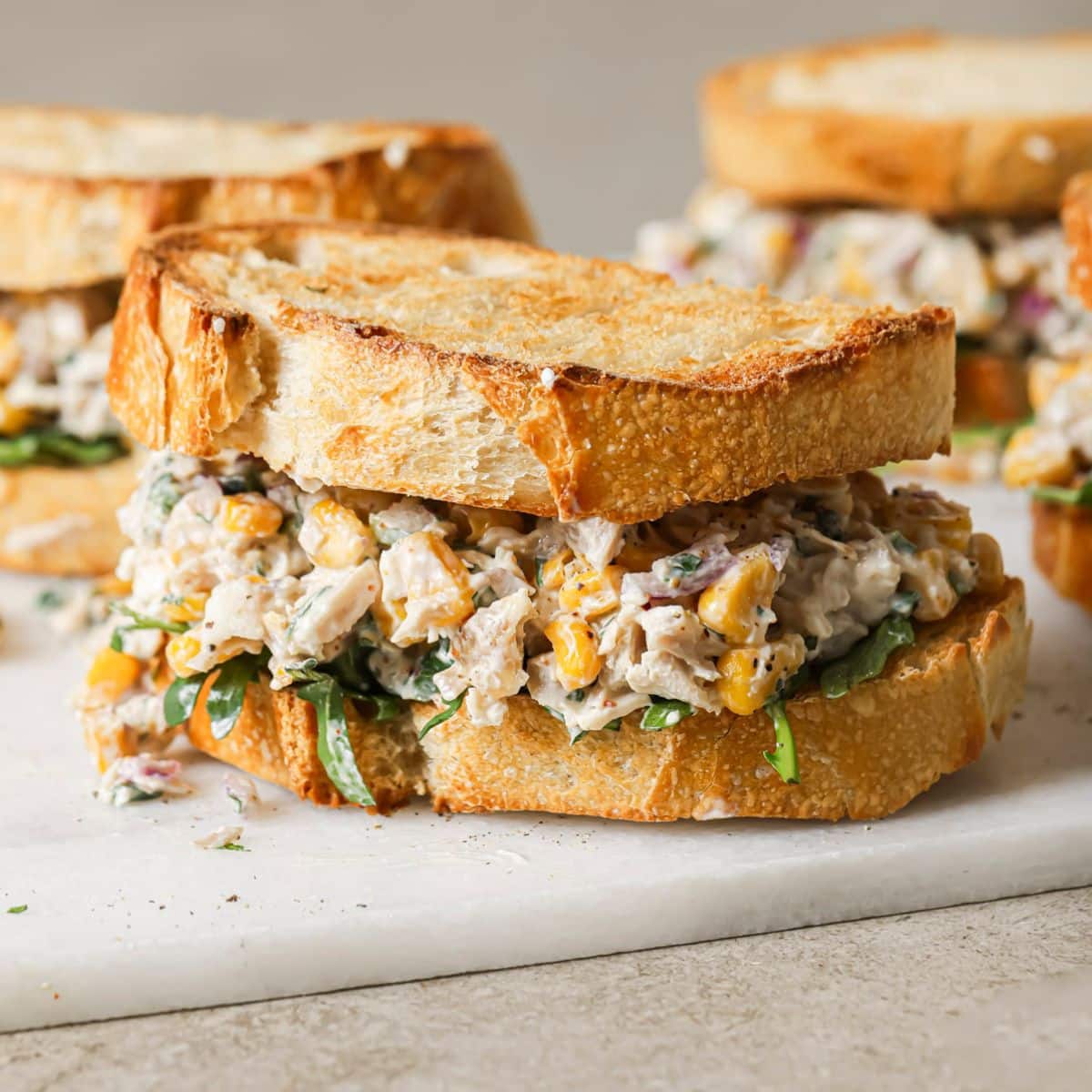 mexican street corn chicken salad piled in between two slices of toasted sourdough
