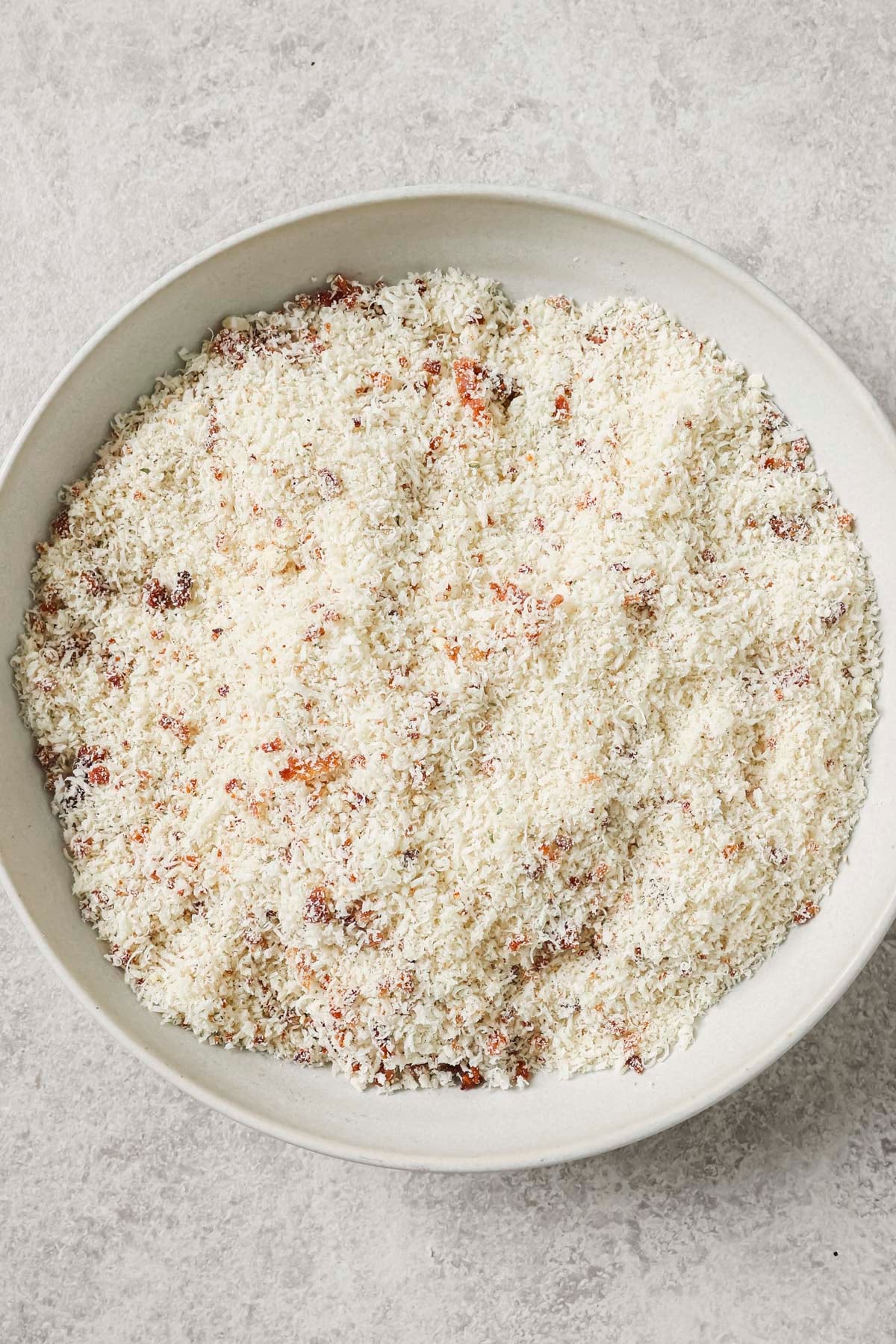 a shallow bowl with panko and parmesan combined