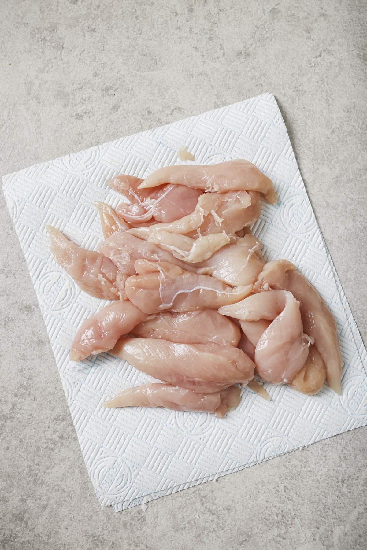patting the chicken tenders dry with a paper towel