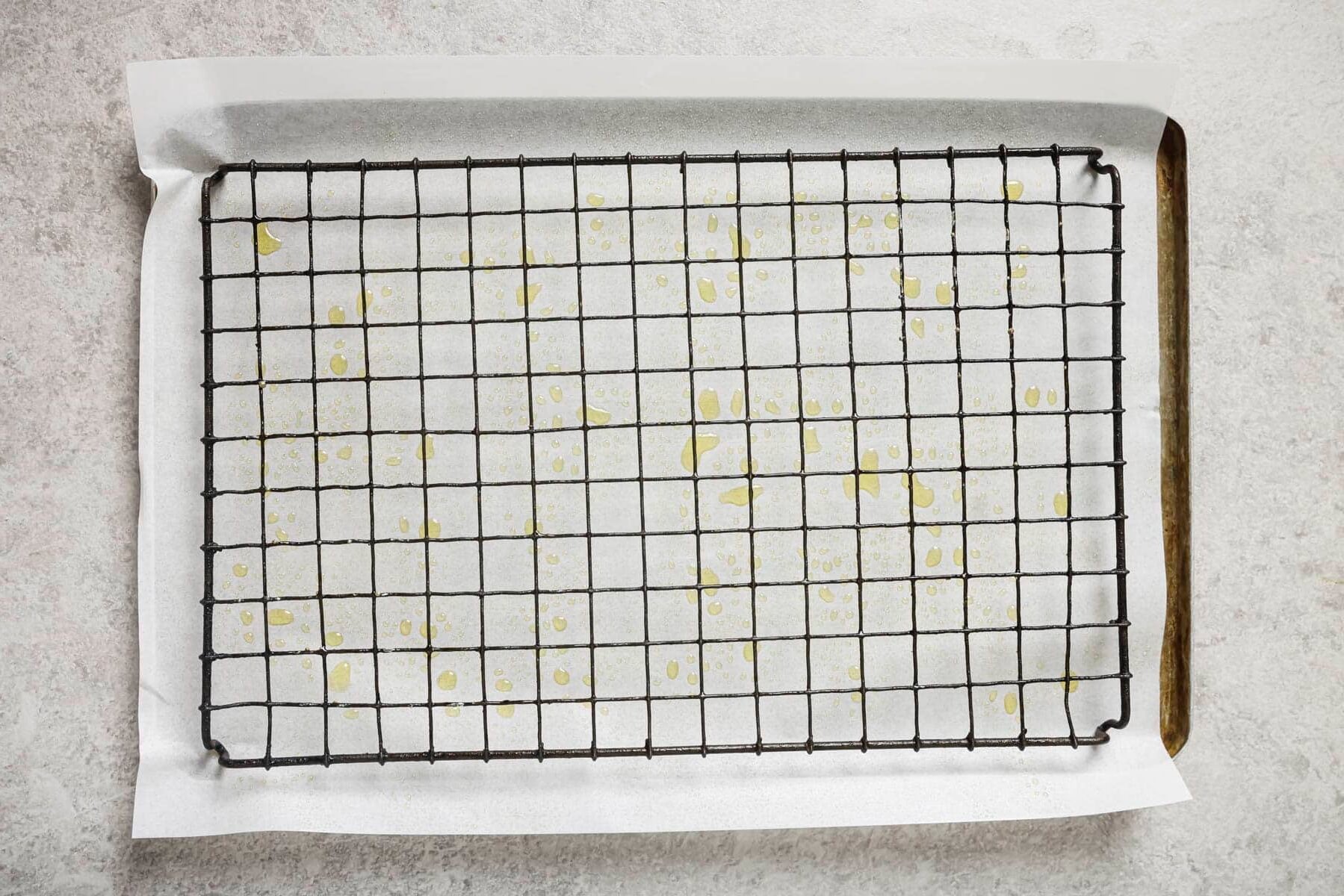 a wire rack on top of a baking sheet sprayed with oil 