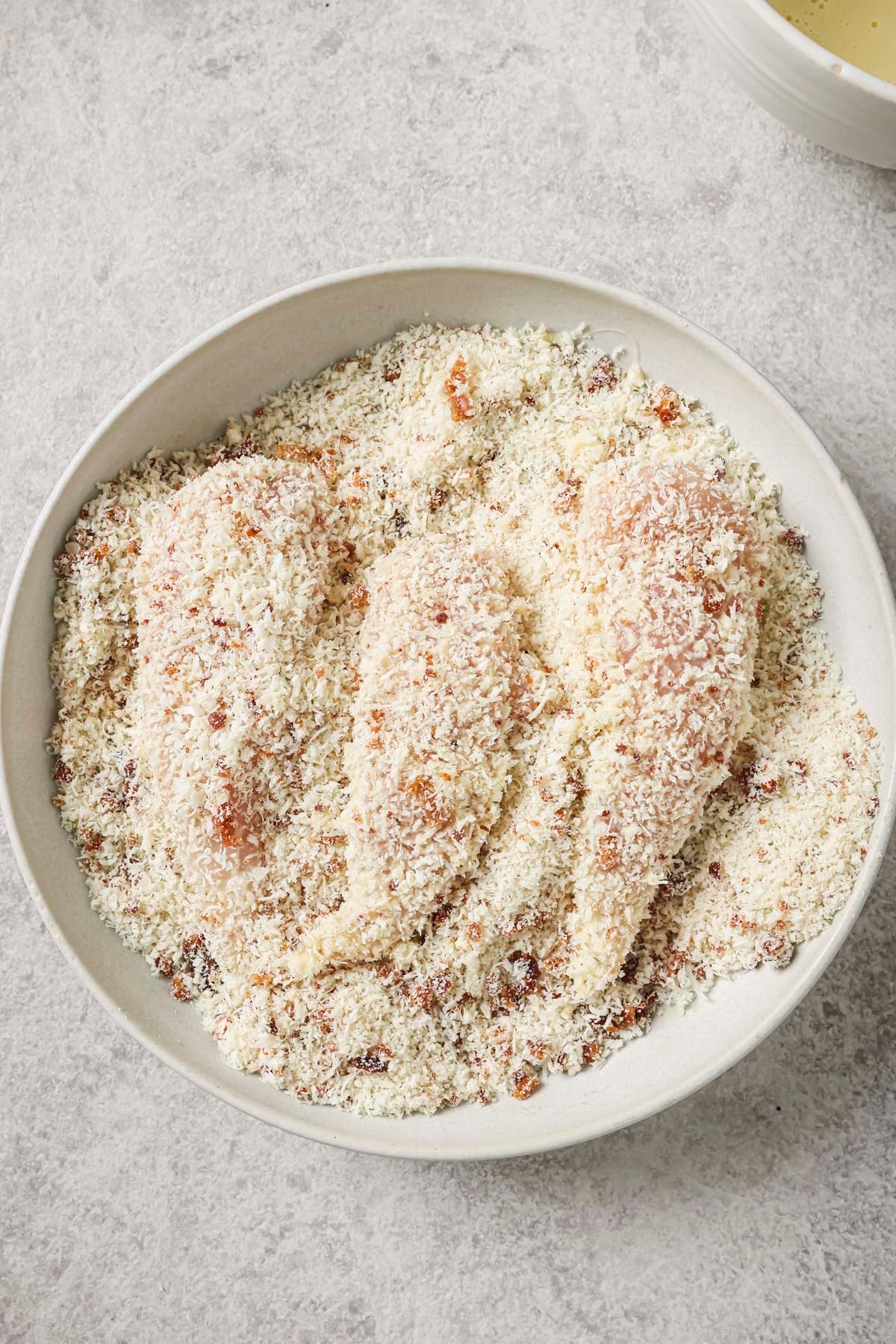 dipping the bacon ranch chicken into the egg, then into the panko mixture