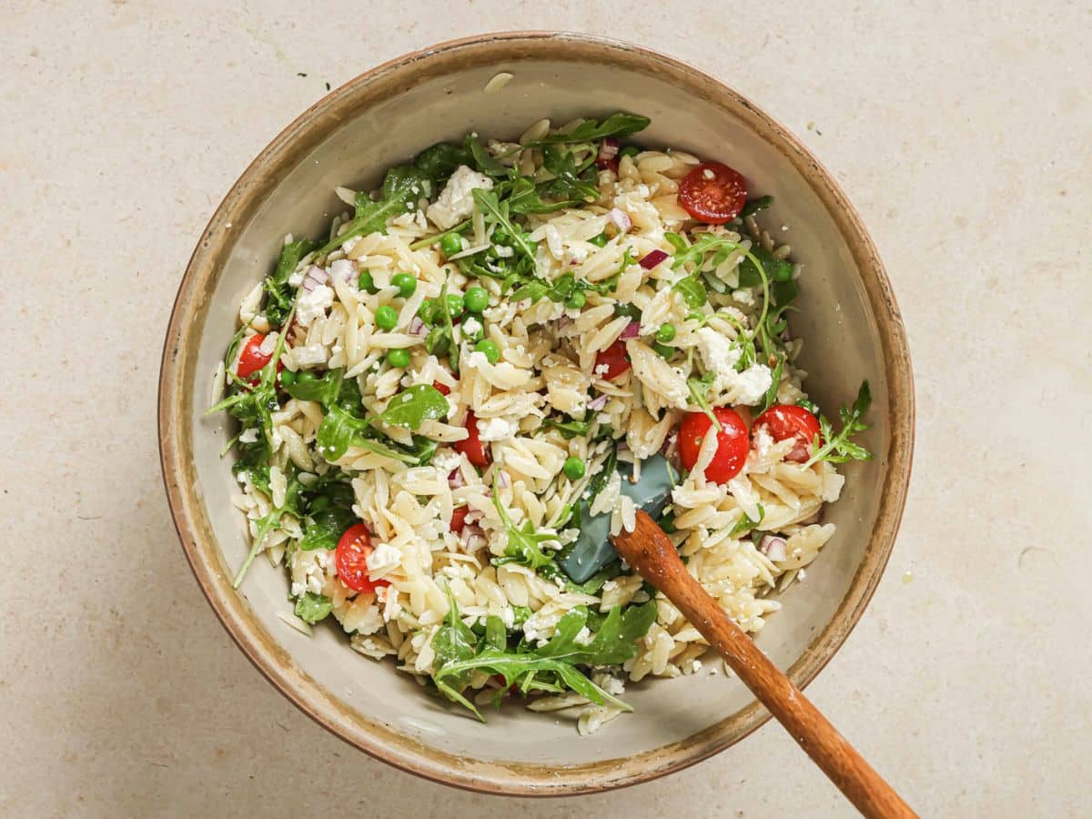 A bowl of lemon orzo pasta salad with tomatoes, feta, and orzo pasta for an easy summer salad. 