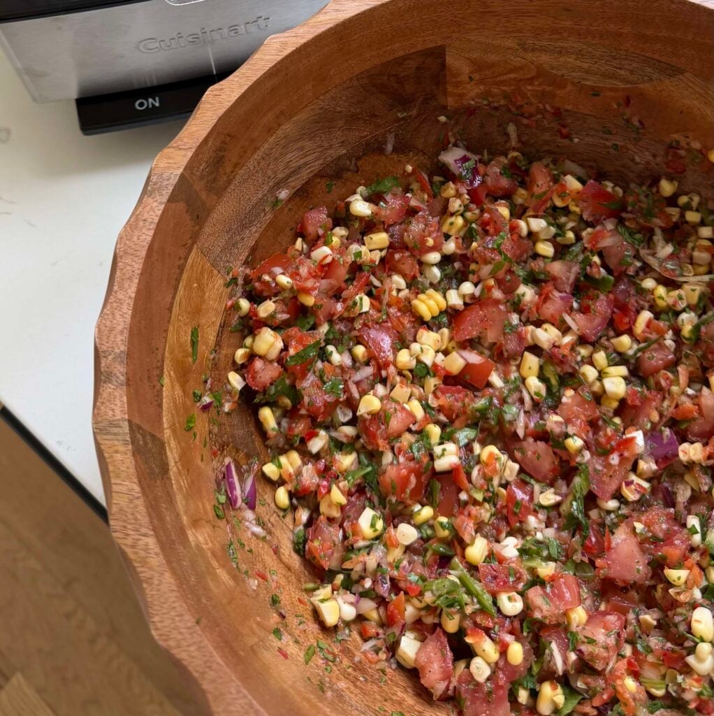 Corn salsa in a large wooden bowl.