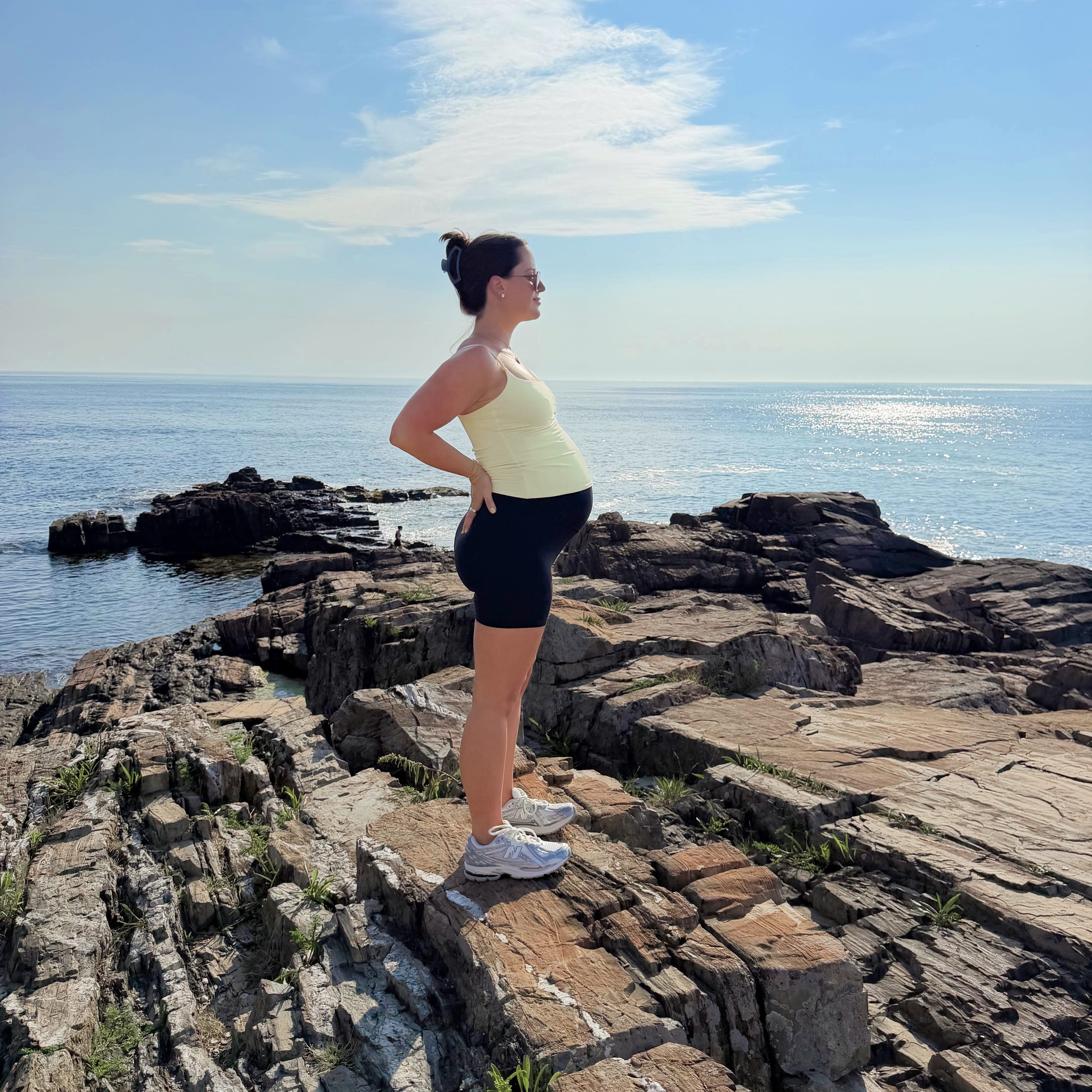 Jordan standing on the cliffs at cliff house in maine.