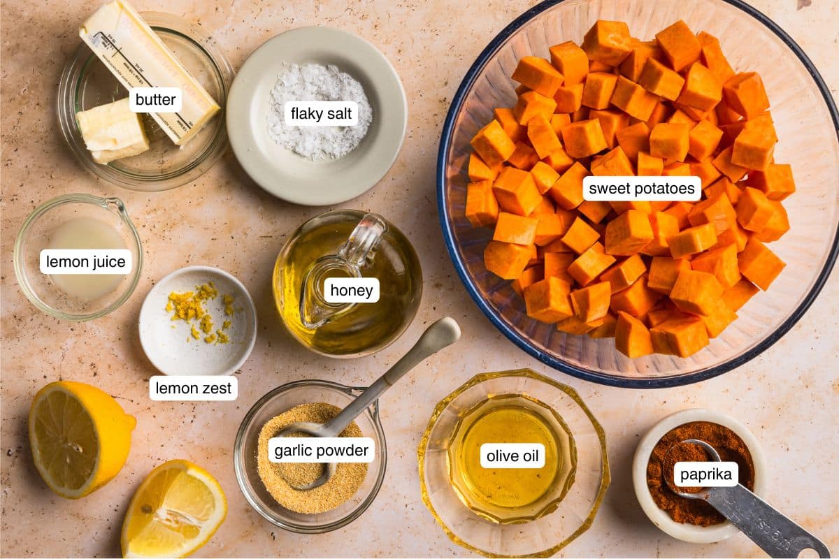 Flat lay of ingredients for honey roasted sweet potatoes on a counter top.