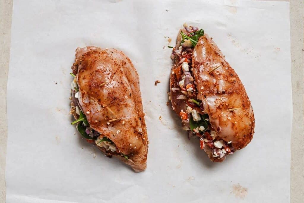 Raw chicken breasts seasoned and stuffed with the spinach feta filling. 